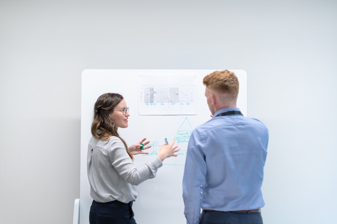 Two people working at a whiteboard