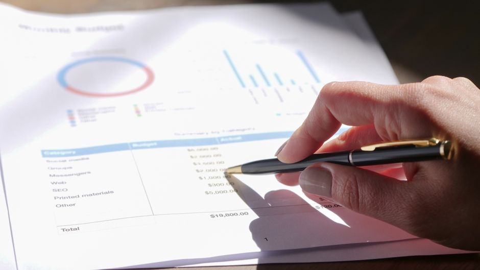 printouts of data and charts being reviewed