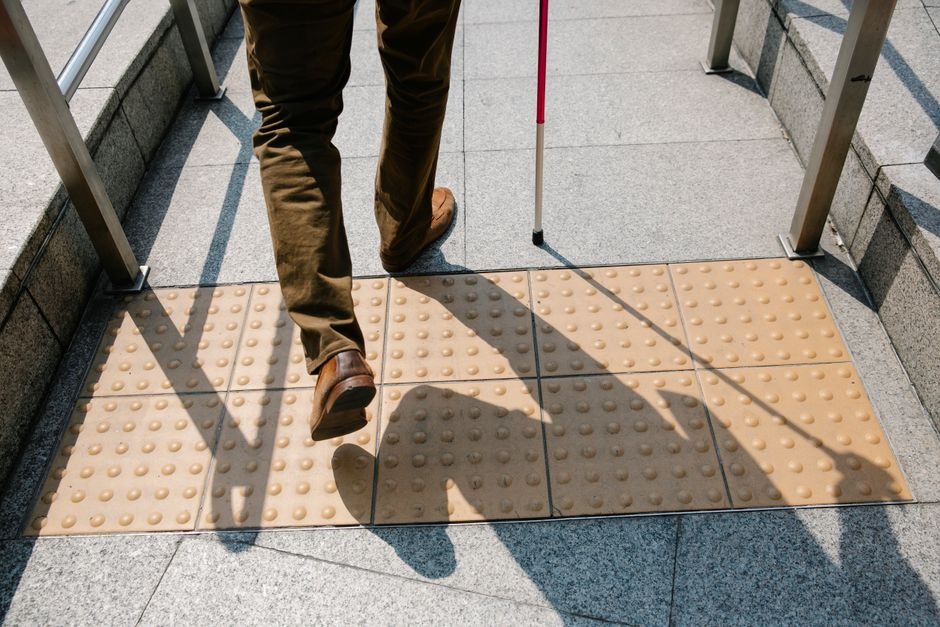 vision impaired person stepping on tactile mat