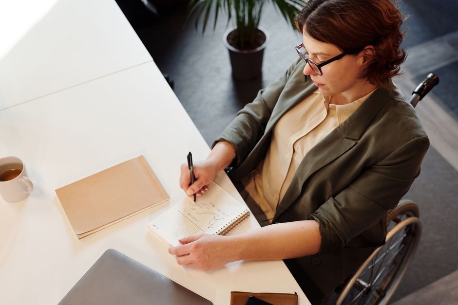 woman in wheelchair working at desk