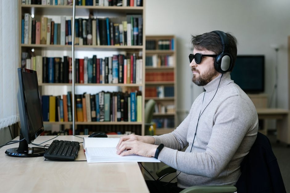 vision impaired man sitting in front of laptop