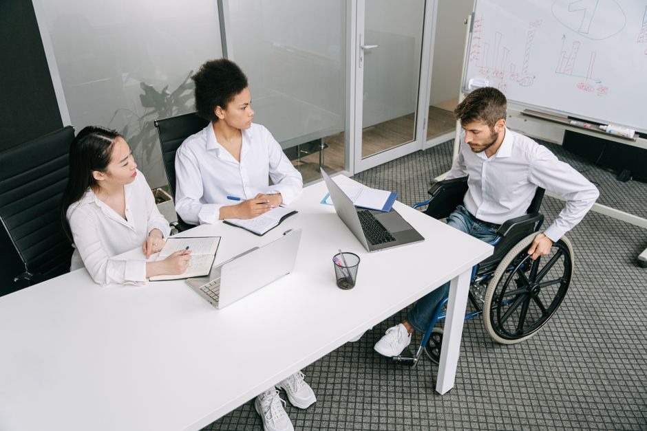 man in wheelchair joining people at table