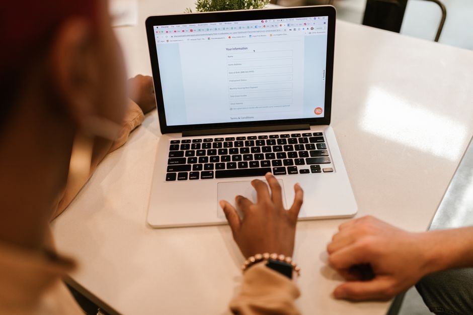 person using a laptop to fill in an online form