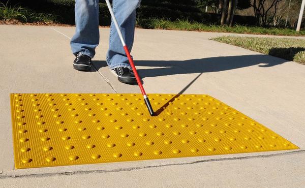 Image of Visually Impaired Person Approaching Truncated Domes