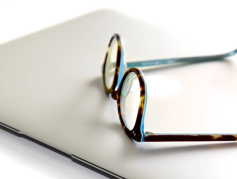 Image of reading glasses and a notebook computer