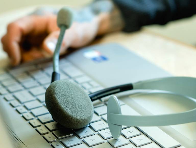 Image of a computer keyboard and headset