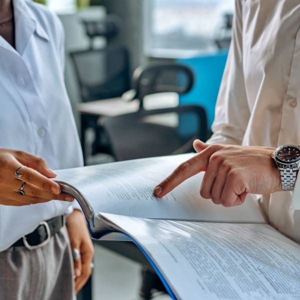 Two people viewing a report.